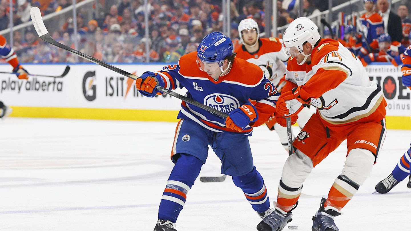 Mar 28, 2026; Edmonton, Alberta, CAN; Edmonton Oilers forward Matt Savoie (22) and Anaheim Ducks defensemen John Carlson (74) battle for a loose puck during the third period at Rogers Place. Mandatory Credit: Perry Nelson-Imagn Images