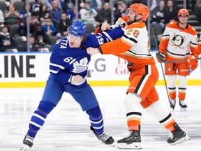 Toronto Maple Leafs' Michael Pezzetta (61) fights with Anaheim Ducks Jeffrey Viel (28) during a game.