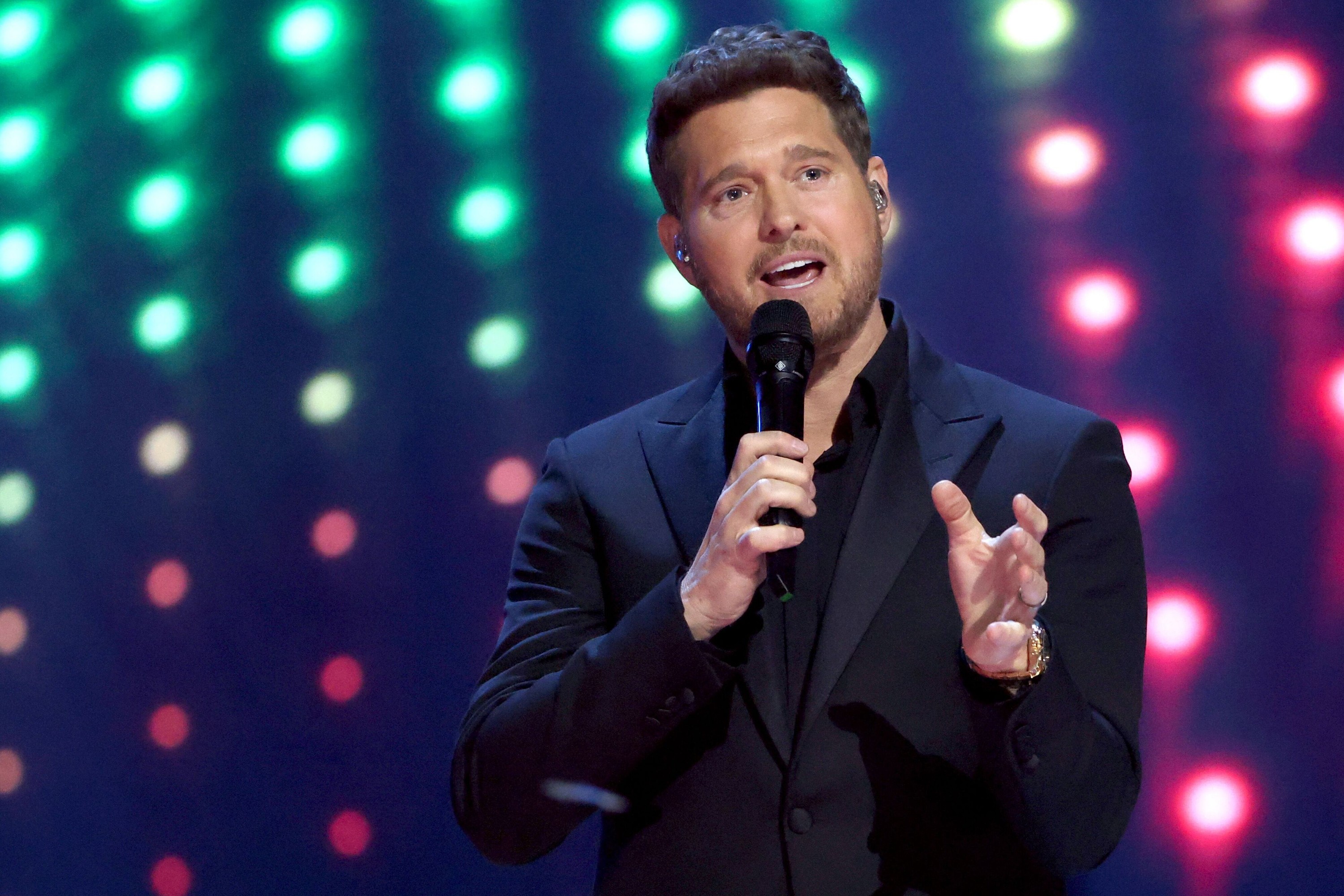 Michael Bublé on stage with bright multi-coloured lights behind him, hosting the Juno Awards in Vancouver March 30, 2025.