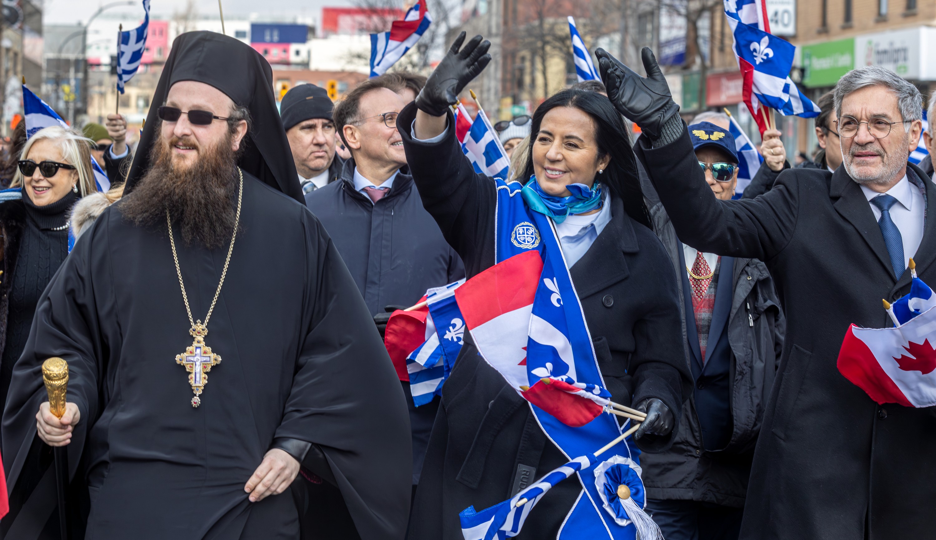 Montreal Mayor Soraya Martinez Ferrada waves in the middle of a crowd at the Greek Independence Day parade.