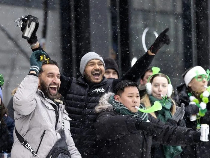  Spectators brave the steady snowfall as they cheer the start of the St. Patrick’s Parade in Montreal on Sunday, March 22, 2026.