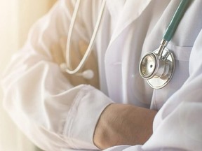 A doctor with their arms crossed and a stethoscope hanging down.