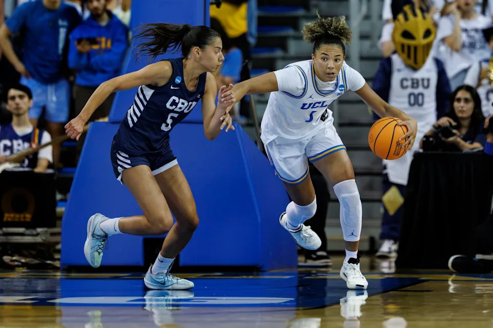 UCLA guard Kiki Rice dribbles up the floor under pressure from California Baptist guard Filipa Barros.