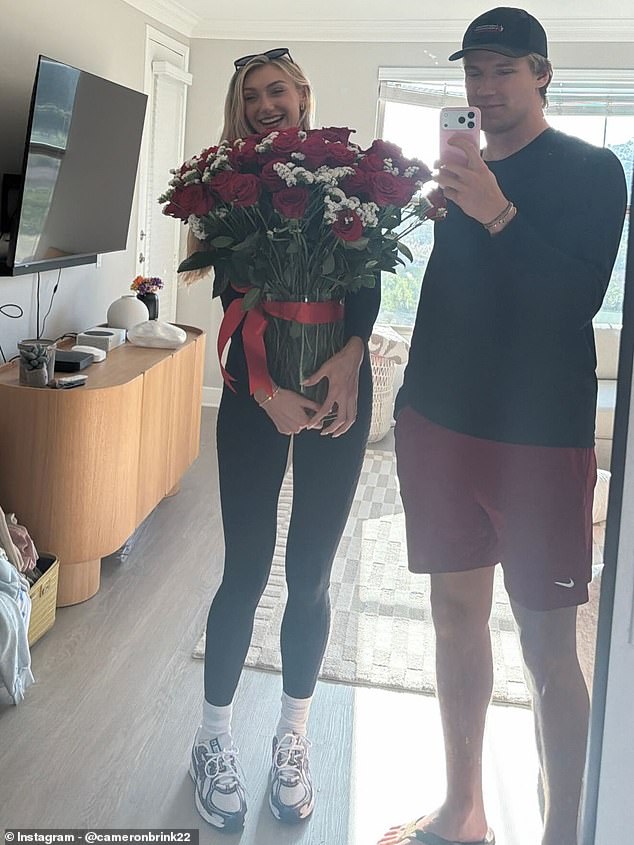 She was captured clutching a massive bouquet of red roses alongside her fiancé, Ben Felter