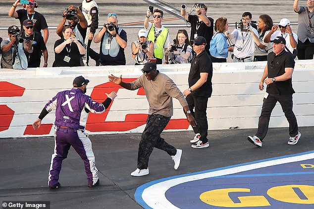 Michael Jordan slaps five with driver Tyler Reddick after their fourth win of the year