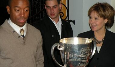 B.C. Lions players Geroy Simon and Jason Arakgi meet visitors to the B.C. legislature for a photo session with the Grey Cup Friday.
