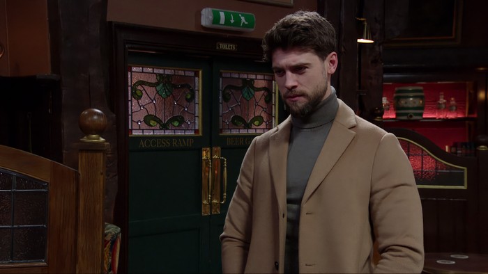 Ned Porteous as Joe Tate standing in the Woolpack in Emmerdale.
