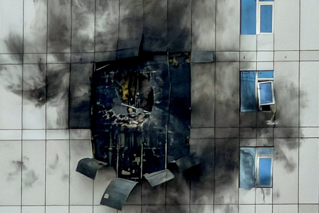 A hole in the side of a building can be seen after an airstrike.