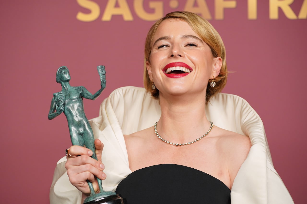 women smiling with award