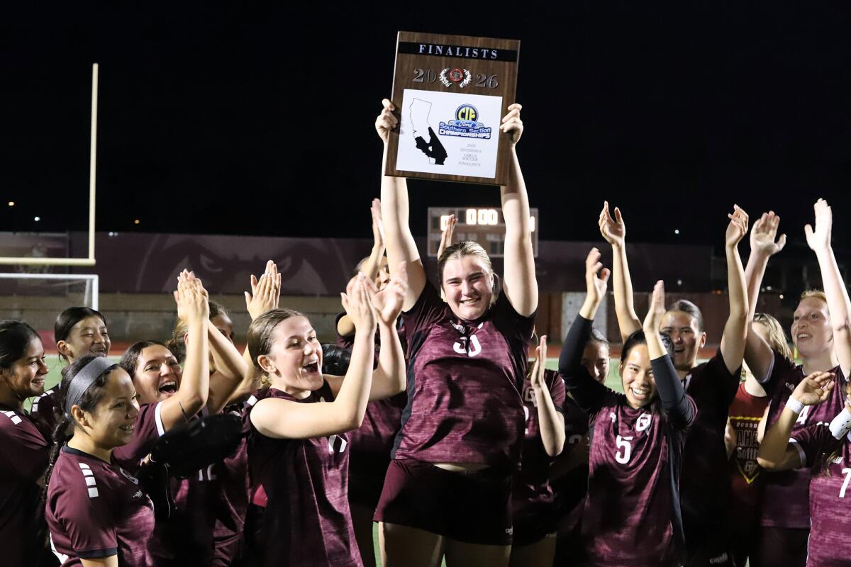 Ocean View's Charlotte Johnson (30) raises the CIF finalist plaque on Friday night.