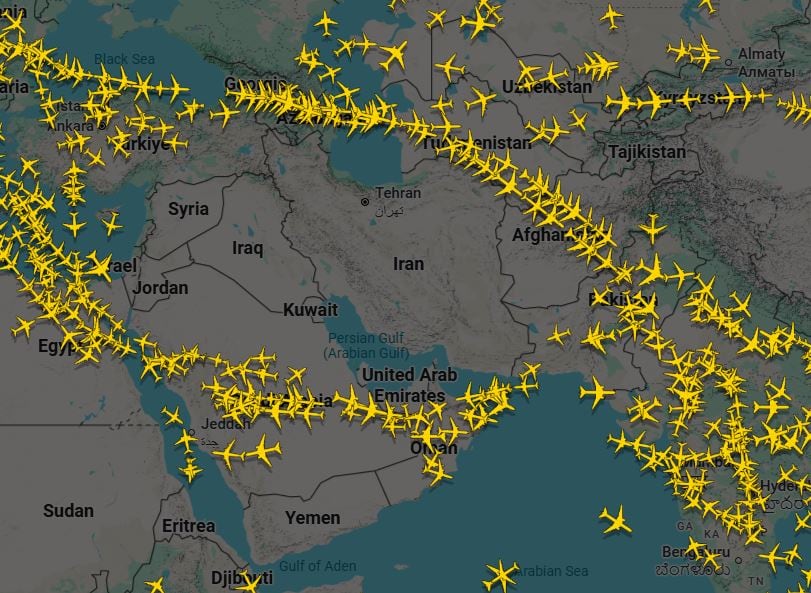 An image of digital map with hundreds of yellow airplane icons spread over the map with a noticeable gap of Middle East countries.