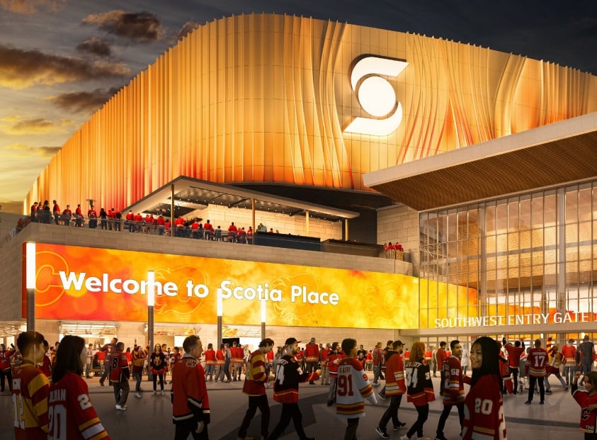 An exterior view of an arena lit in red and orange with the words "Welcome to Scotia Place" visible along its wall.