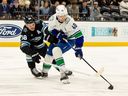 Vancouver Canucks centre Elias Pettersson moves around Utah Mammoth defenceman Mikhail Sergachev on Feb. 2 in Salt Lake City. 
