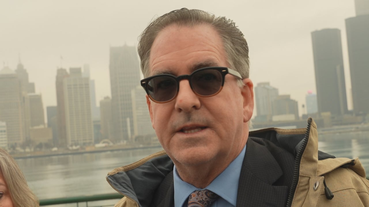 Head shot of Masse in sun glasses with a river behind him