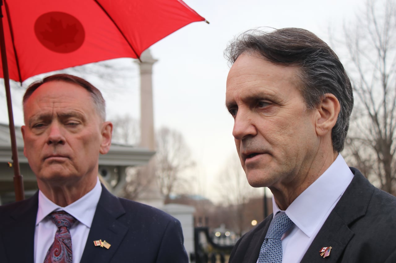 The two men stand side by side