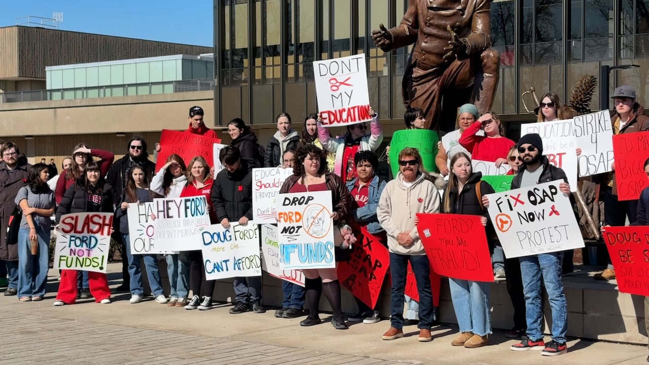 Crowd lined up with signs.