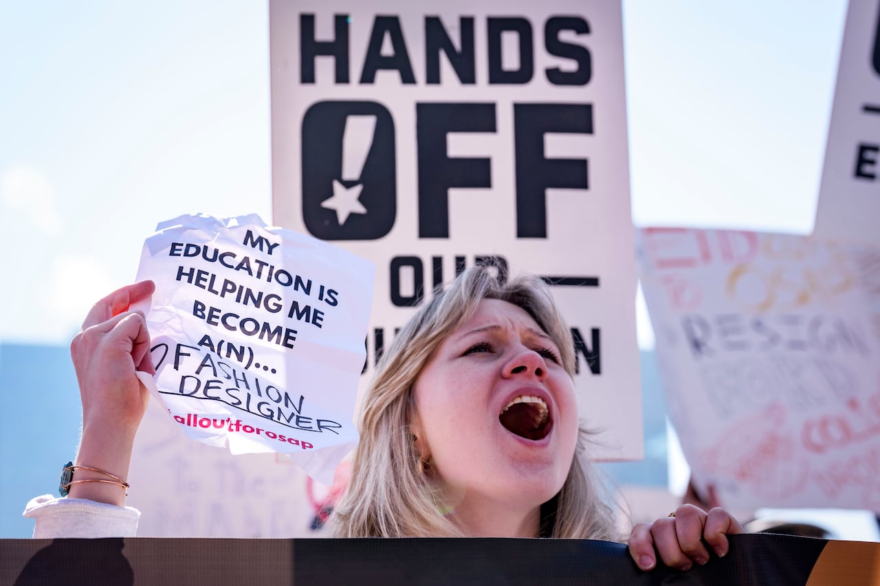 Closeup of student protestor with a sign.
