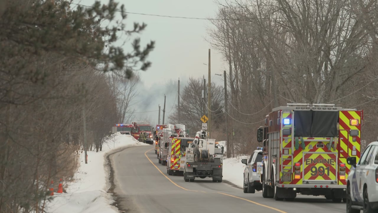 Emergency vehicles parked along a road.