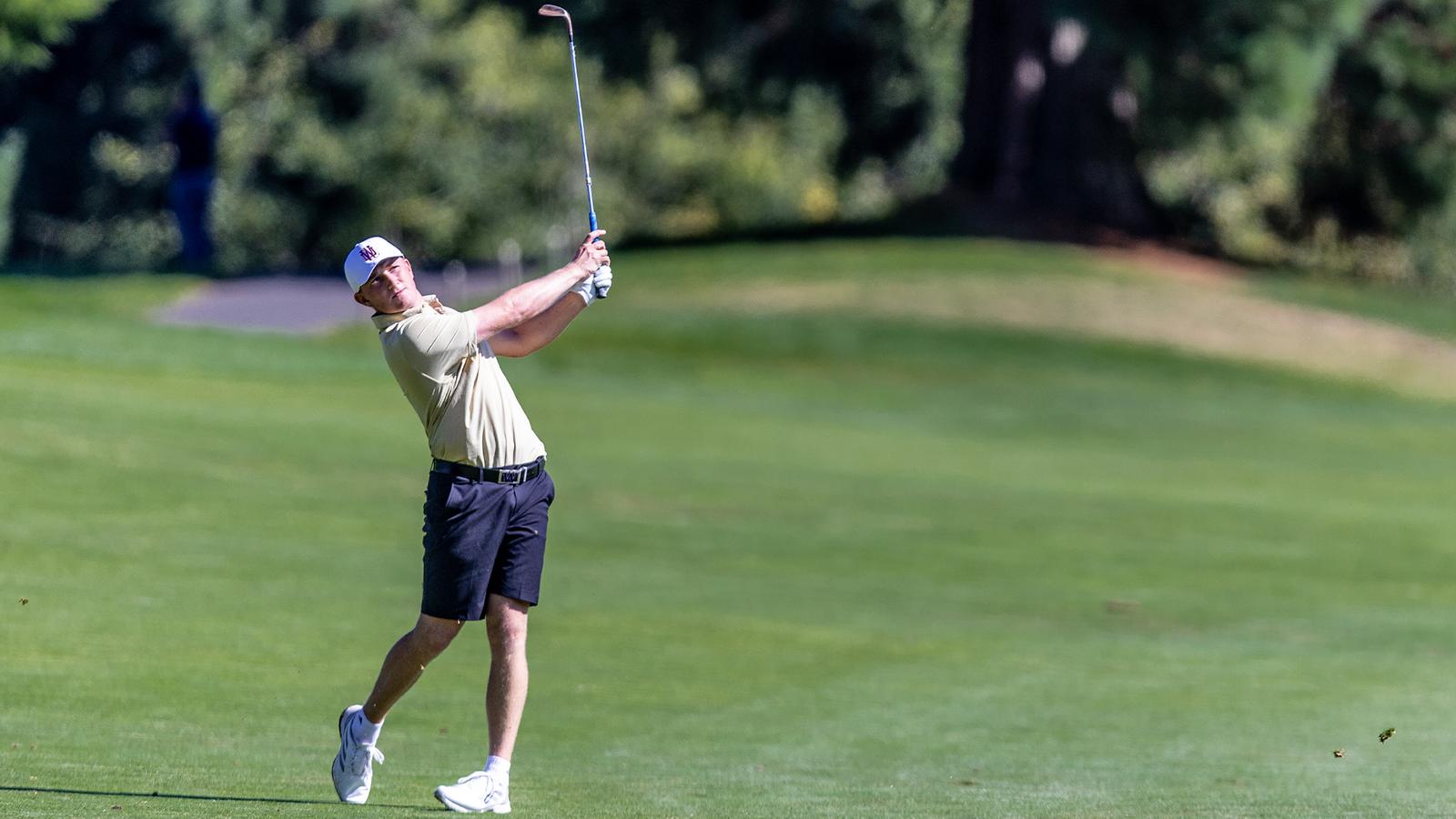 Finn Koelle hits a shot to a par 3 over water