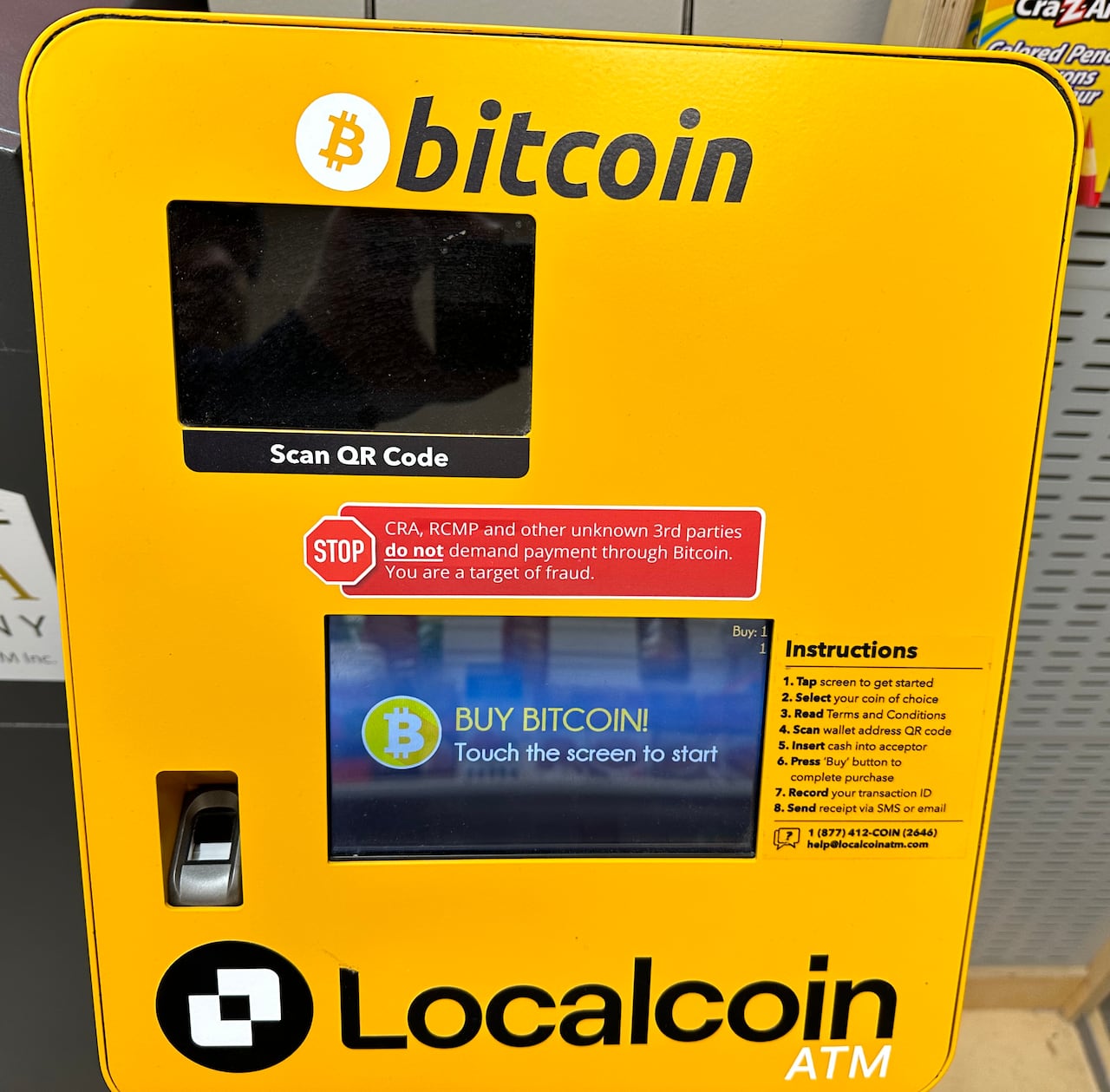 A bitcoin ATM sign warns that users could be fraud targets.
