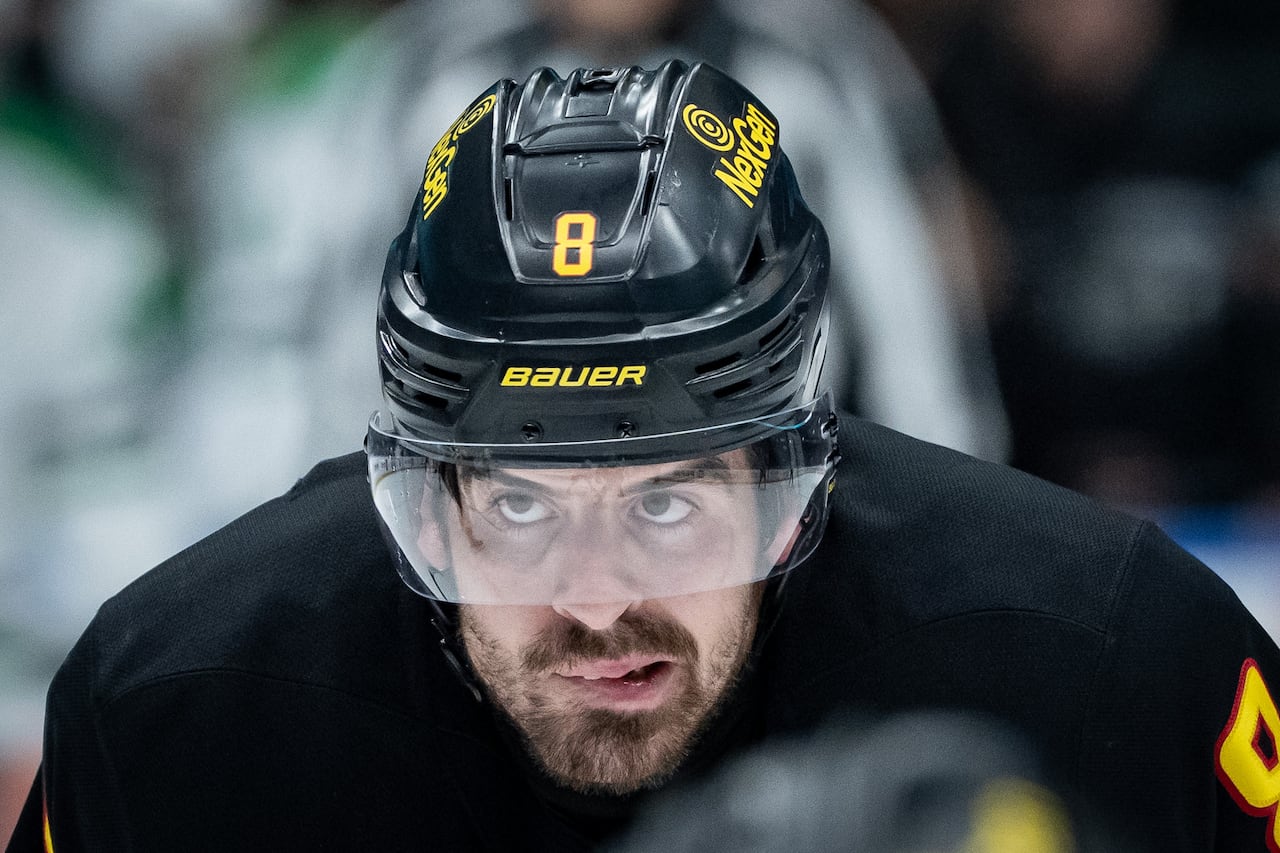 A hockey player bites his lip.