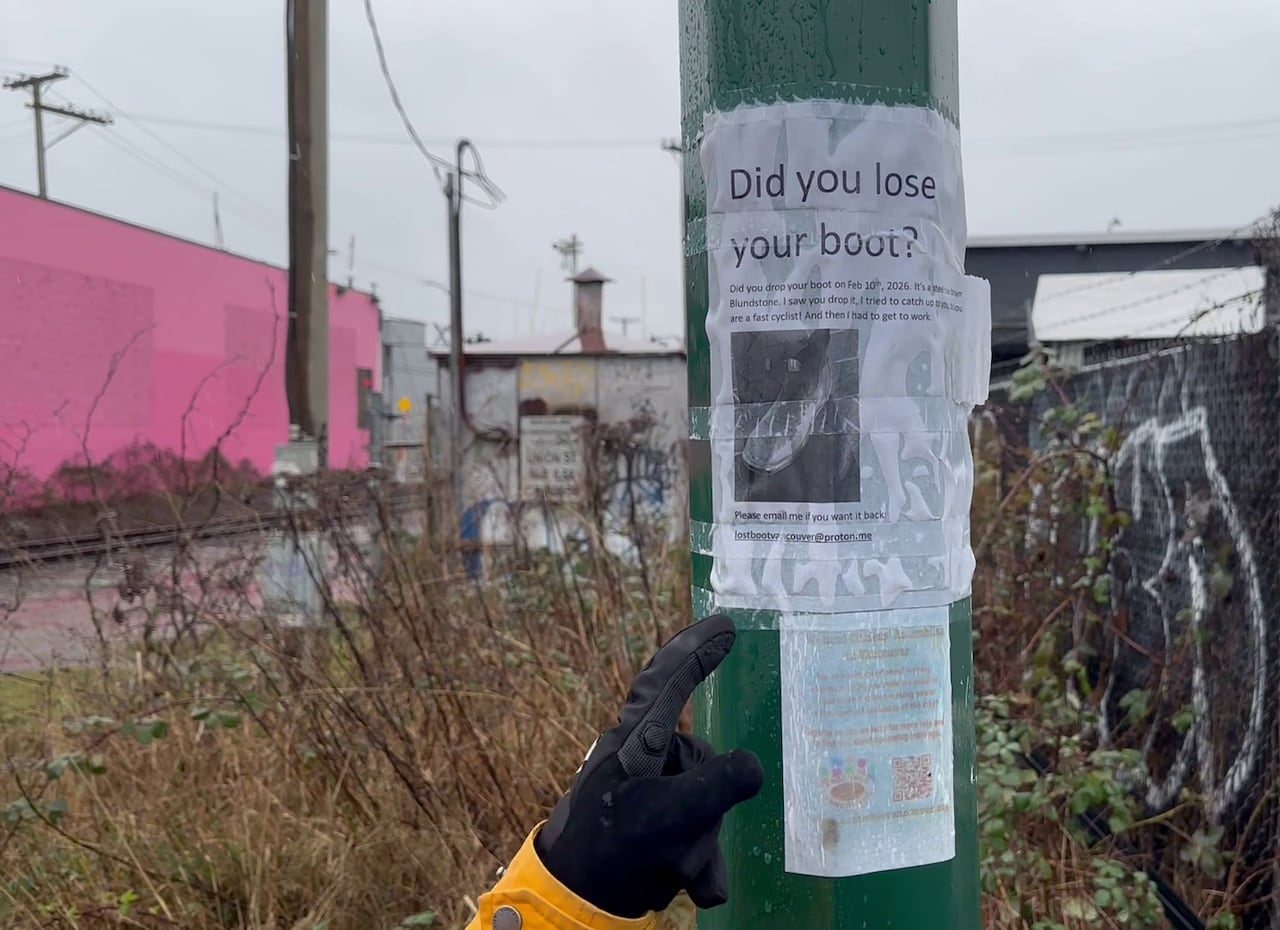 A woman points to a poster reading 'Did you lose your boot?'