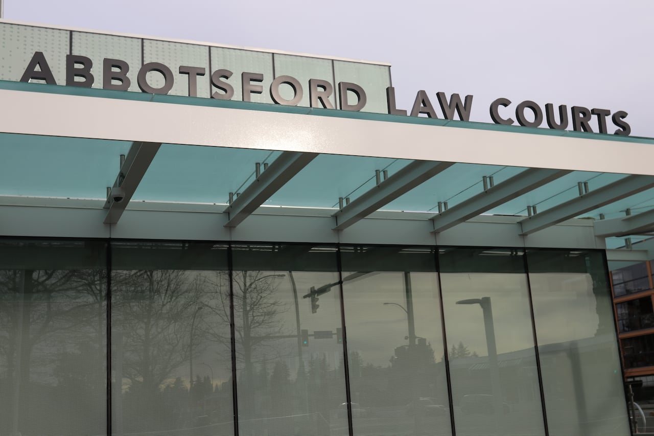 A simple text signage 'Abbotsford Law Courts' is installed in front of a building.