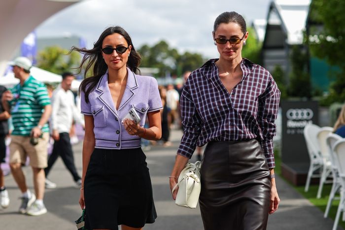 Alexandra Leclerc, wife of Charles Leclerc of Monaco and Ferrari, walks in the paddock with model and girlfriend of Carlos Sainz of Spain and Williams, Rebecca Donldsonduring