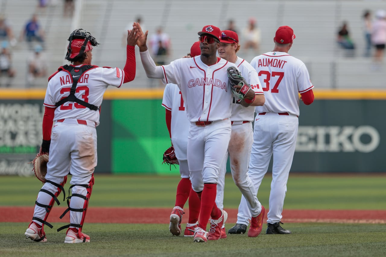 Canadian baseball players celebrate.