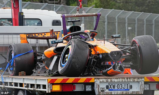 McLaren driver Oscar Piastri of Australia's car is taken from the track track after he crashed during the formation lap ahead of the Australian Formula One Grand Prix at Albert Park, in Melbourne, Australia, Sunday, March 8, 2026. (AP Photo/Scott Barbour)
