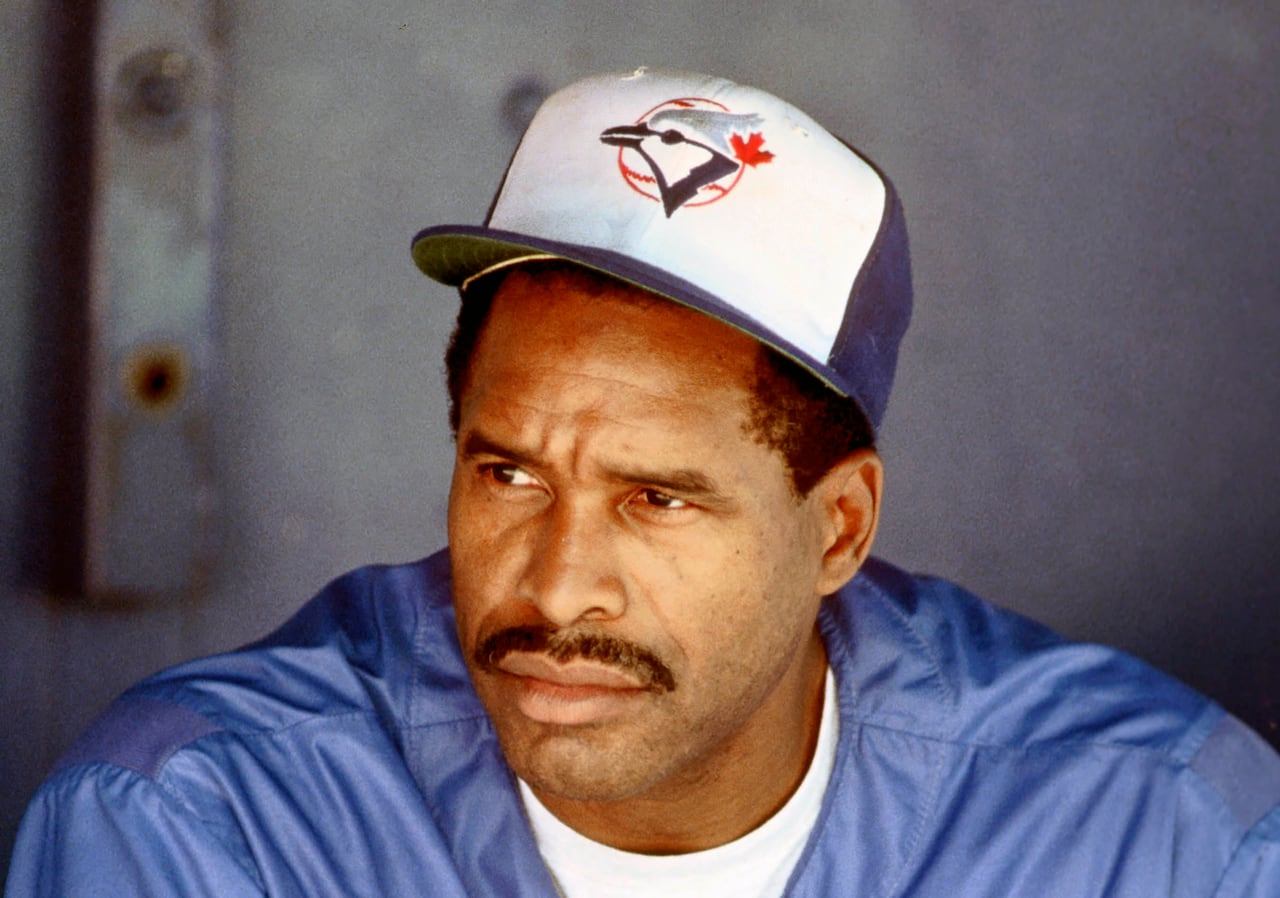 A baseball player sitting in the dugout