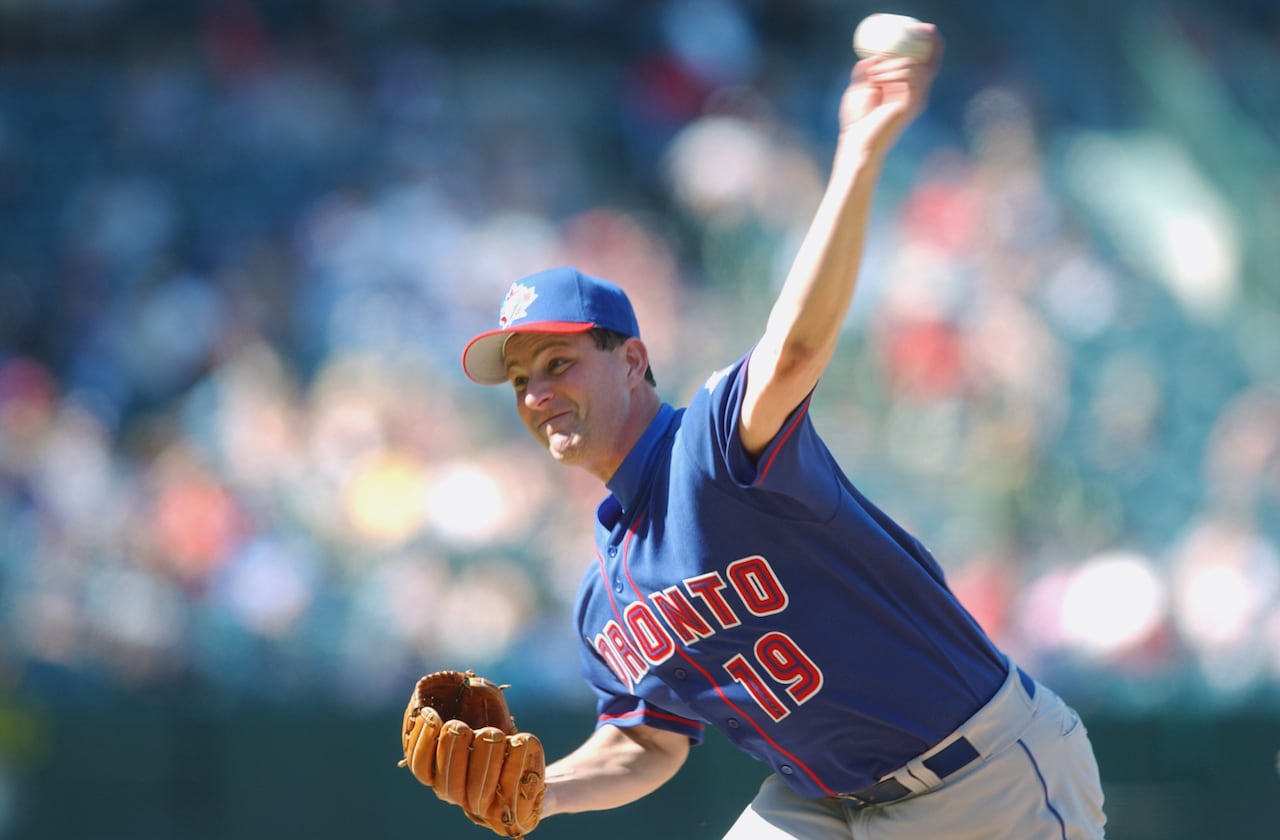 A cropped image of a baseball pitcher in the midst of delivering a pitch from the mound