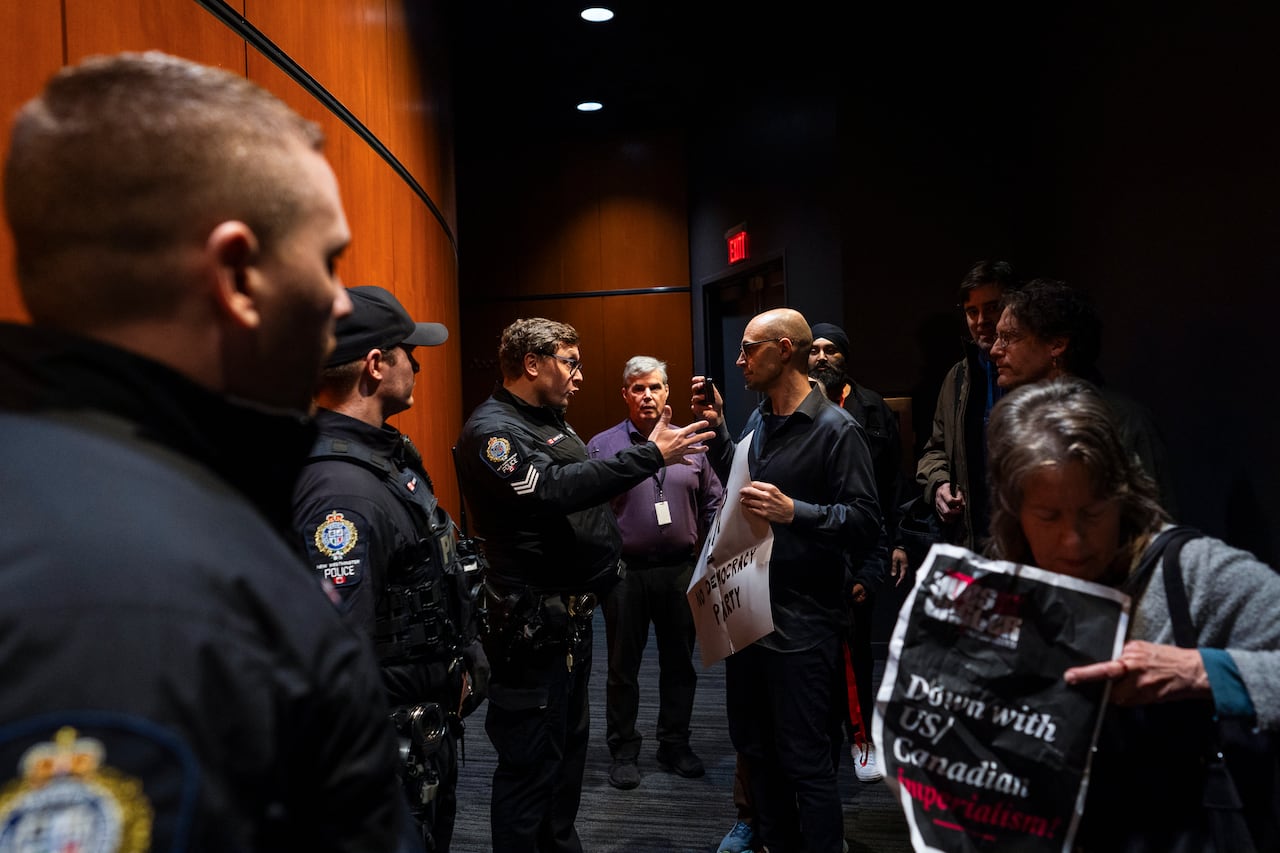 Police confront protesters in a hallway