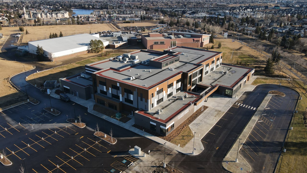 birds eye view of a modern and large school with lots of parking