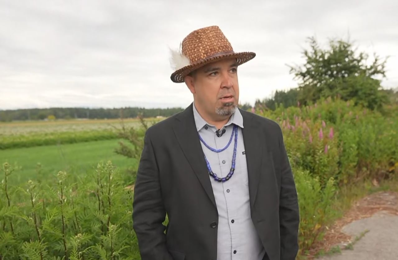 Semiahmoo First Nation Chief Harley Chappell in Surrey, B.C. He is an Indigenous man wearing a suit and a straw hat.