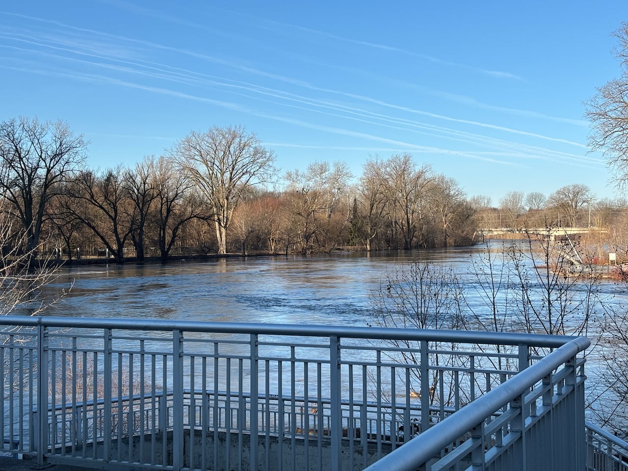 High water levels spill over banks from metal viewing deck. 