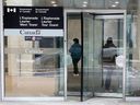 People are seen going into the L'Esplanade Laurier building at 300 Laurier Ave. on Feb. 6, 2026.
