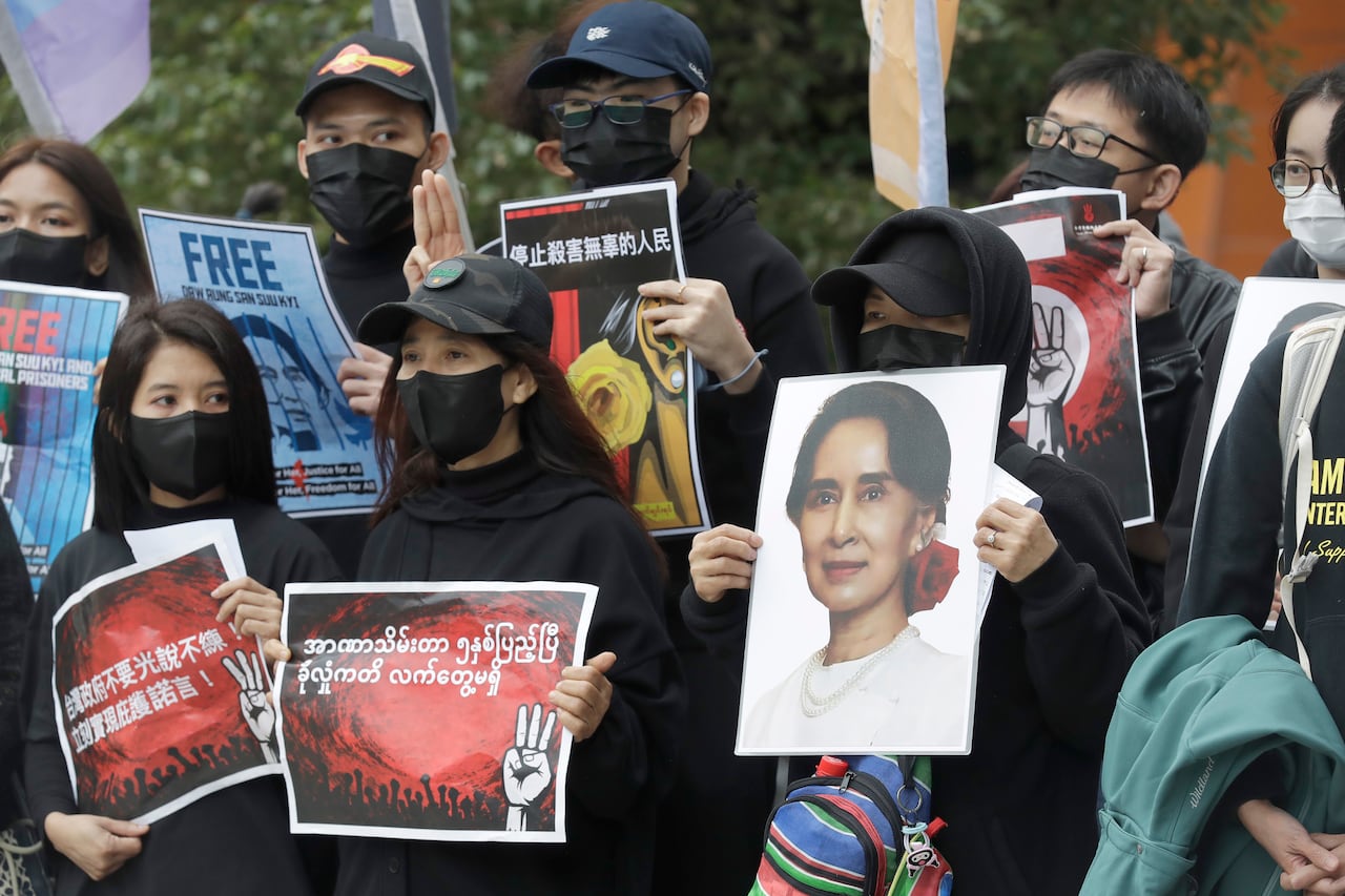 People protest holding signs