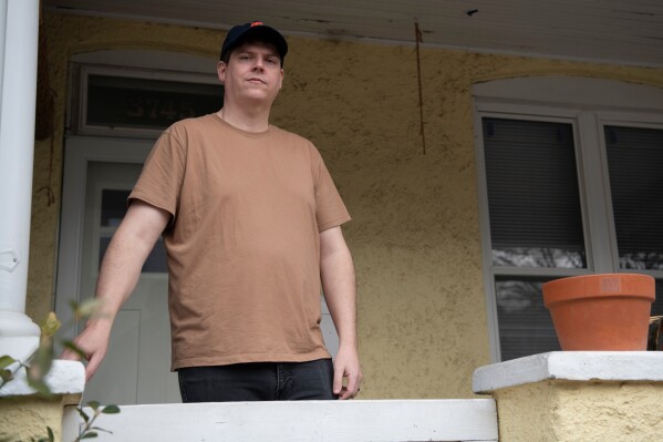 Teddy Bloomquist, who suffered a sewage backup earlier this year, poses at his home in Baltimore on March 5, 2026. (AP Photo/Michael Phillis)