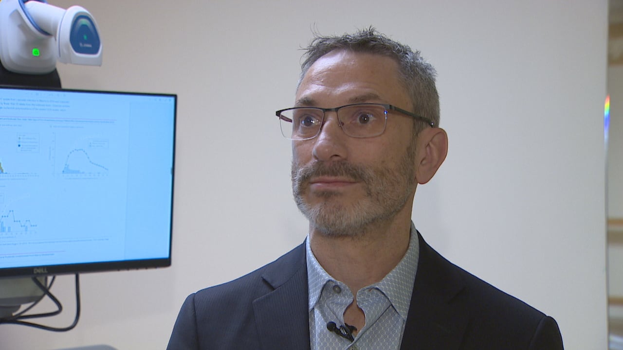 A man looks at a reporter off-camera.