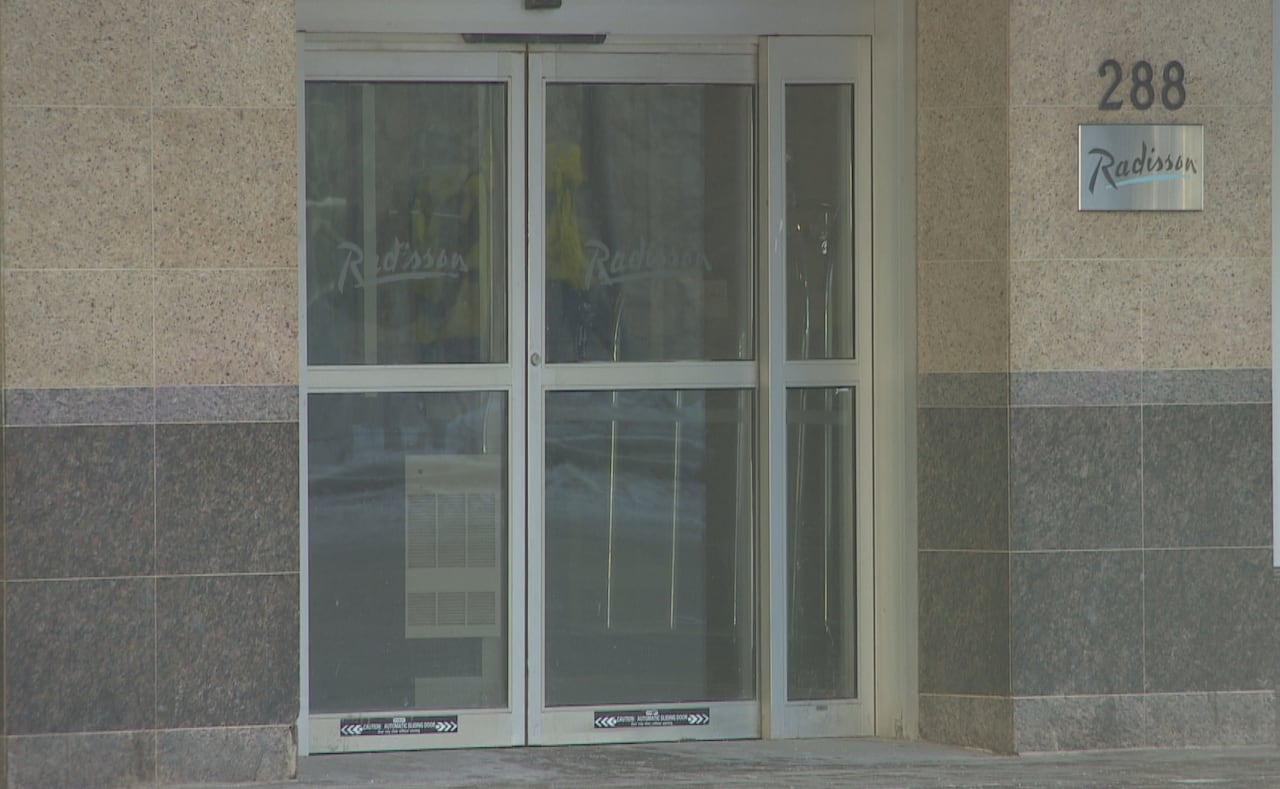 The sliding entrance doors to a downtown hotel are shown.