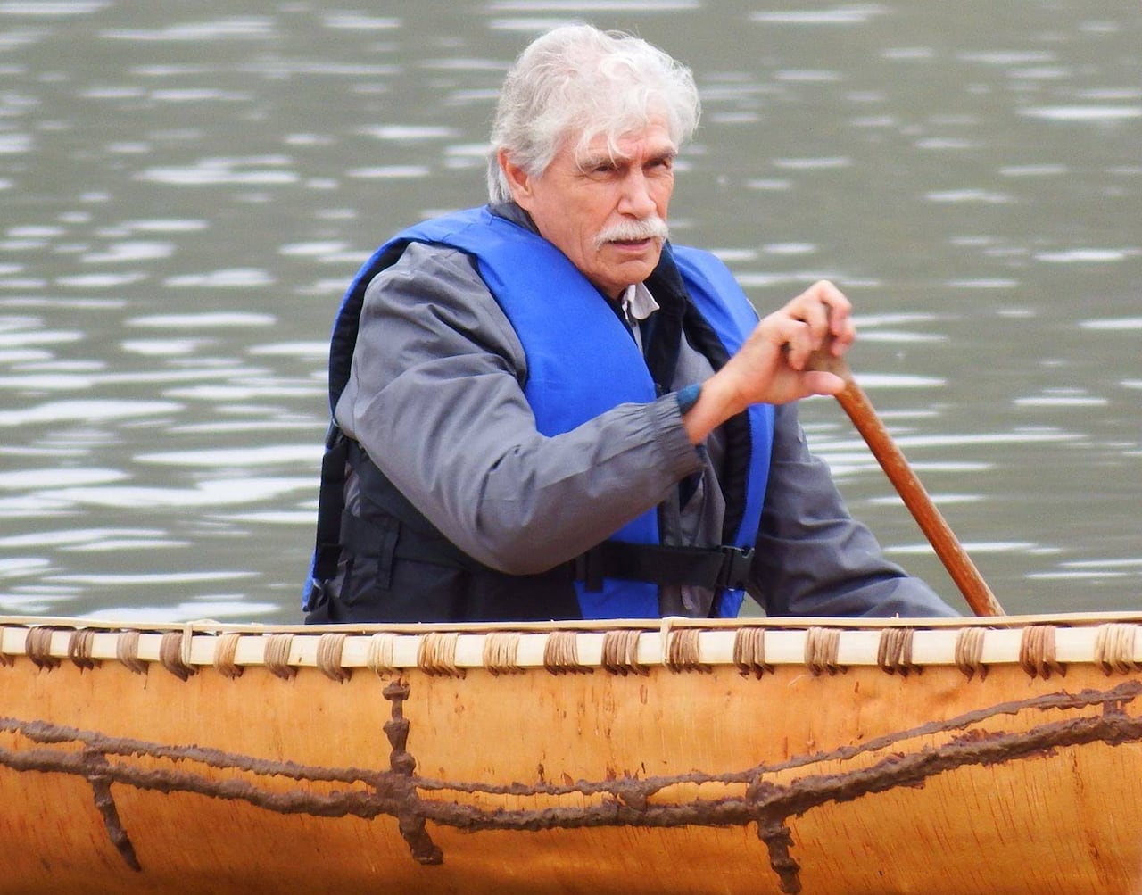 A person is seen in a canoe.