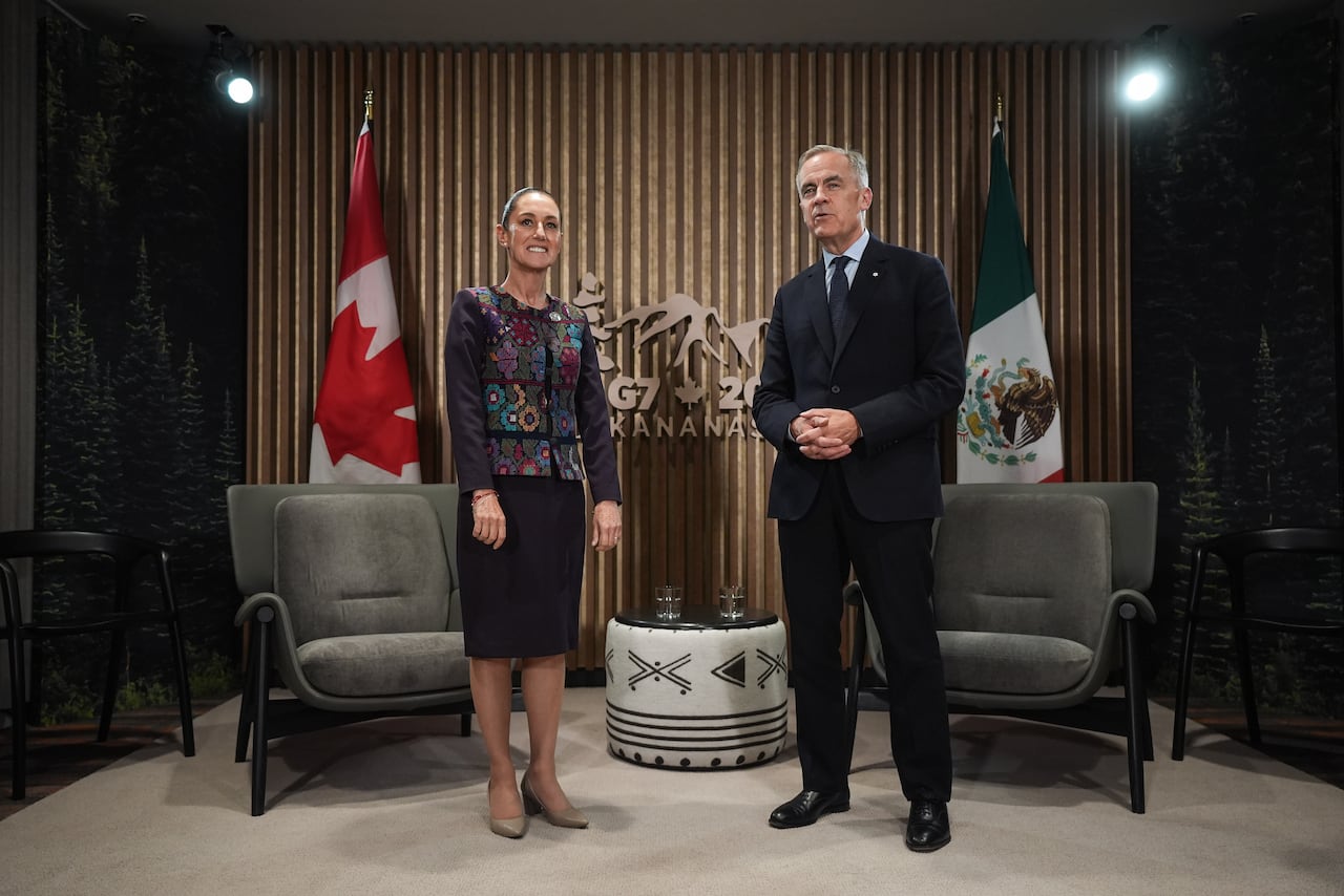 Mexican President Claudia Sheinbaum, left, listens as Canadian Prime Minister Mark Carney speaks before a meeting at the G7 Summit in Alberta..