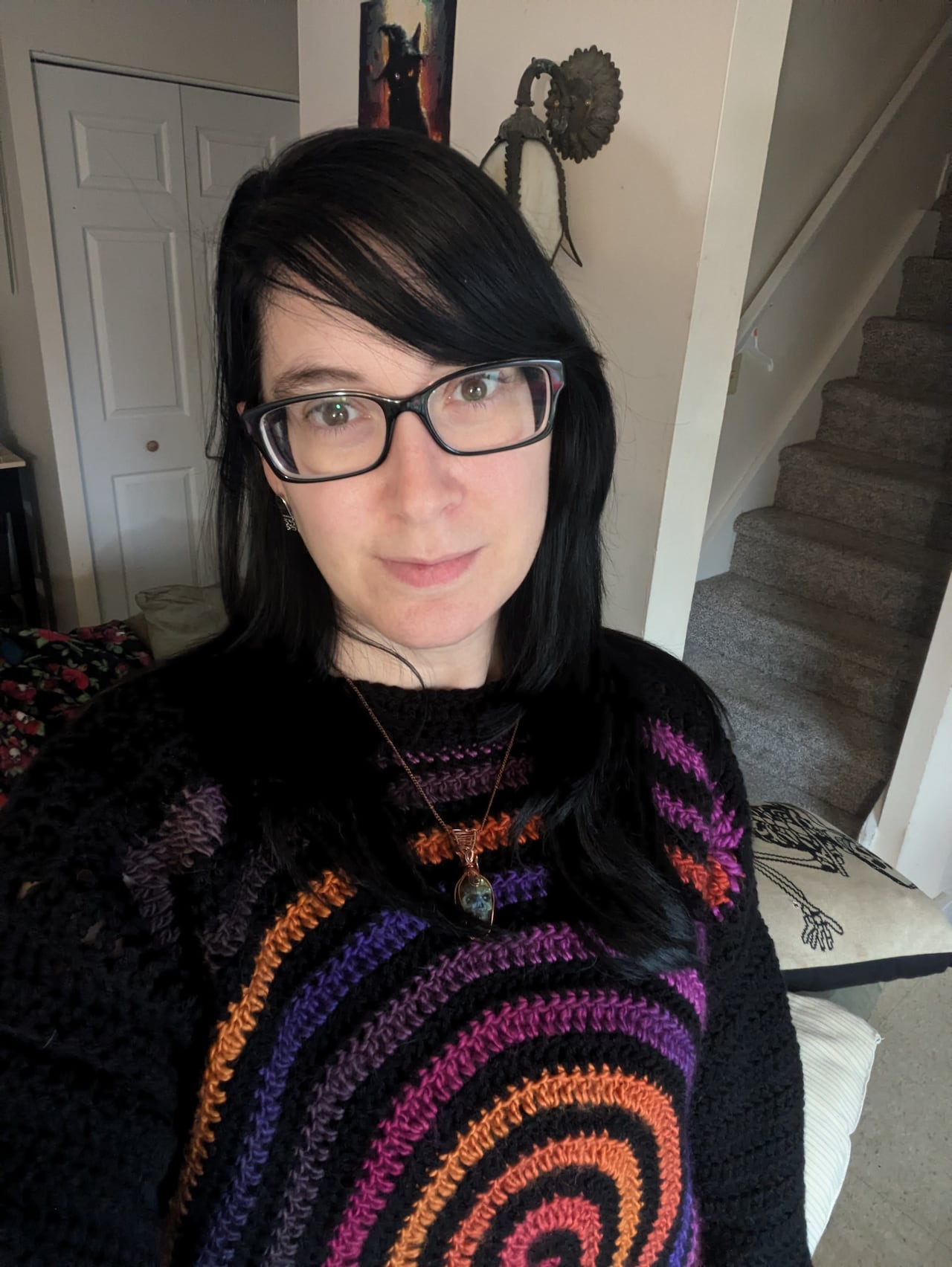 A woman with dark hair and glasses.