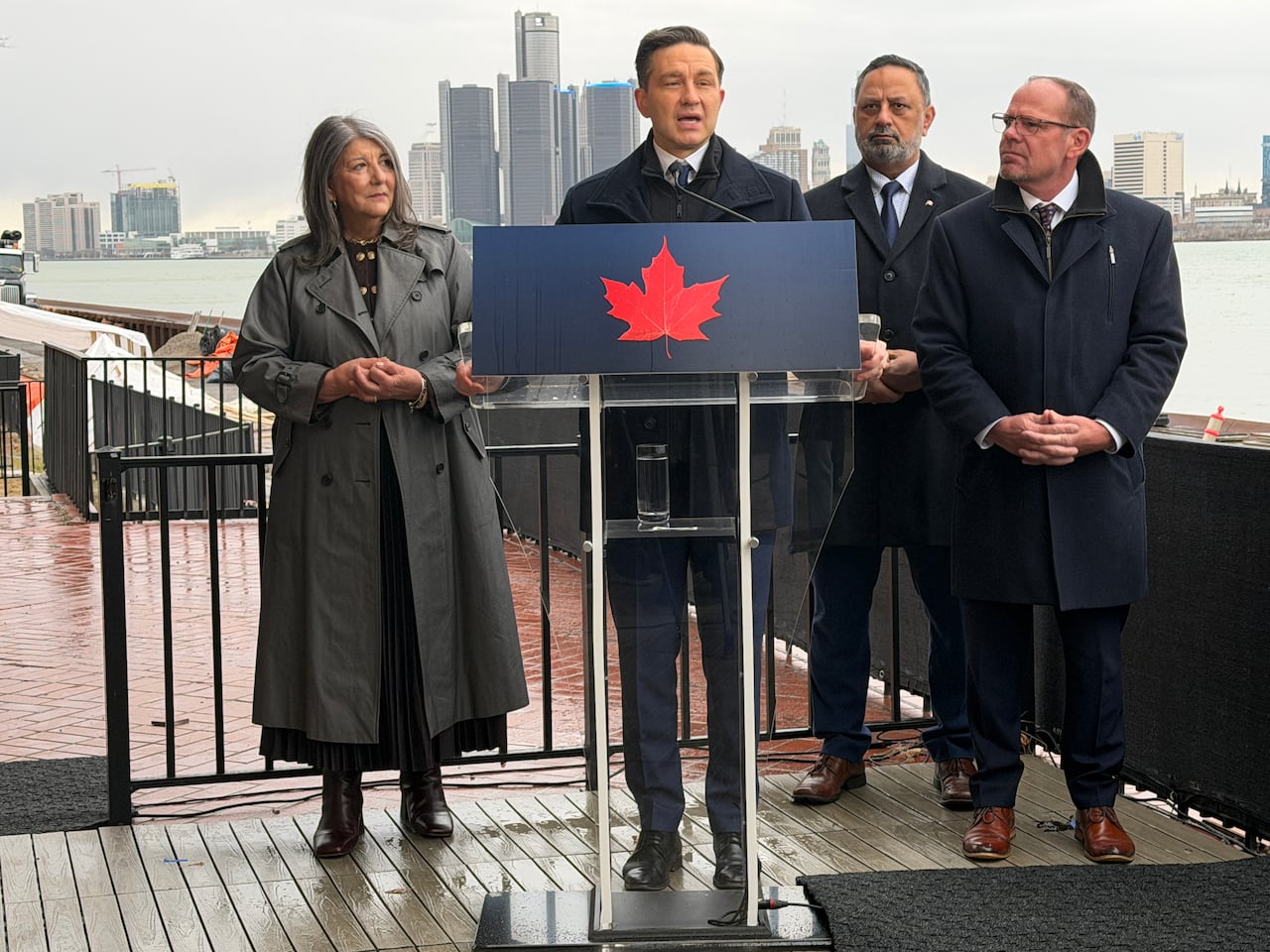 Pierre Poilievre addresses reporters in Windsor, Ont., alongside local Conservative MPs Kathy Borrelli, Hal Gill, and Chris Lewis on the far right.