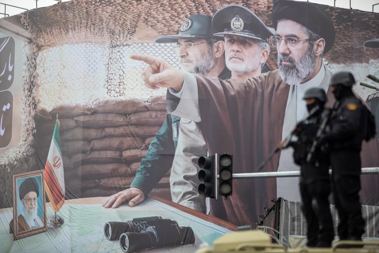A billboard shows a graphic depicting Iran's Supreme Leader with military commanders standing nearby.