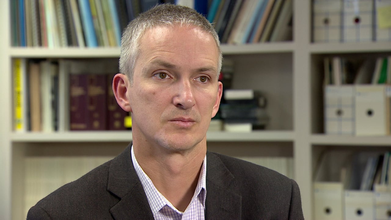 A man wearing a suit is pictured.