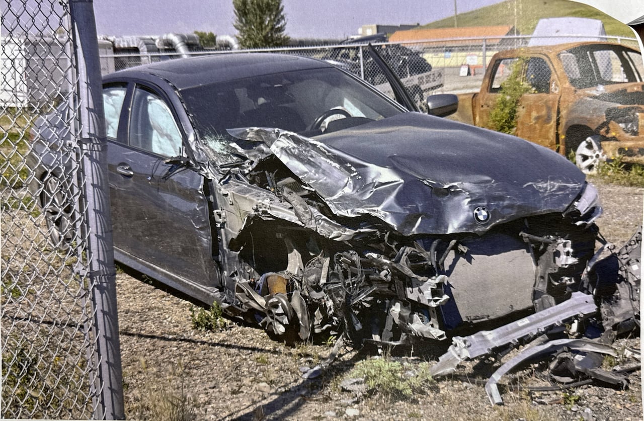 A BMW sedan with a badly damaged front end.