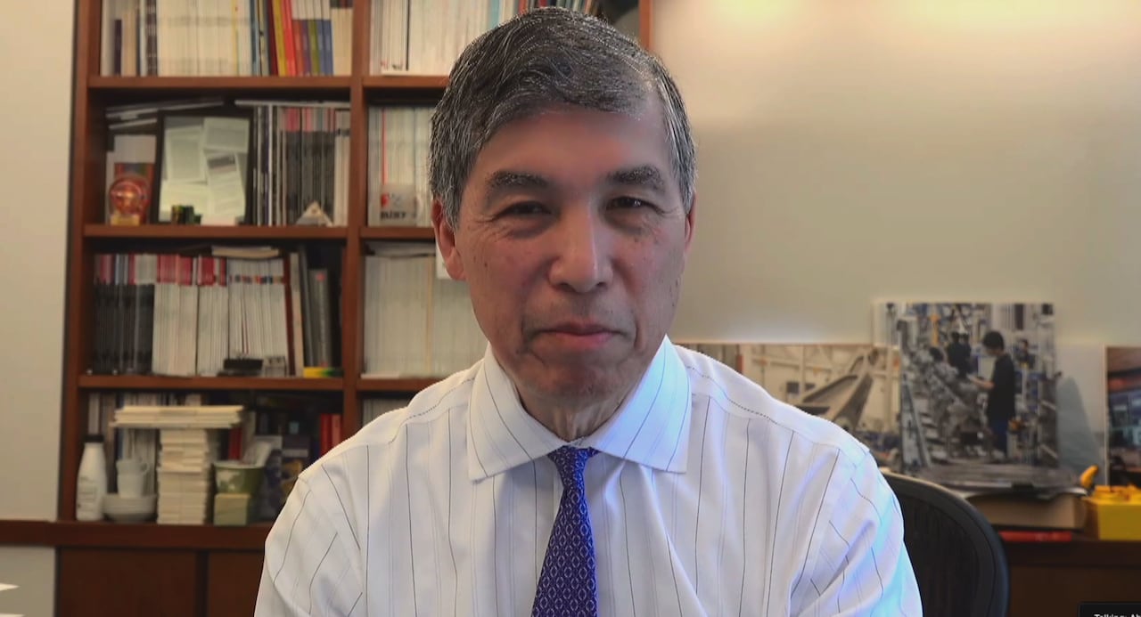 Man sitting in office with bookshelf