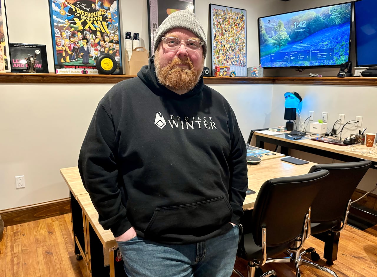 Man leaning against table